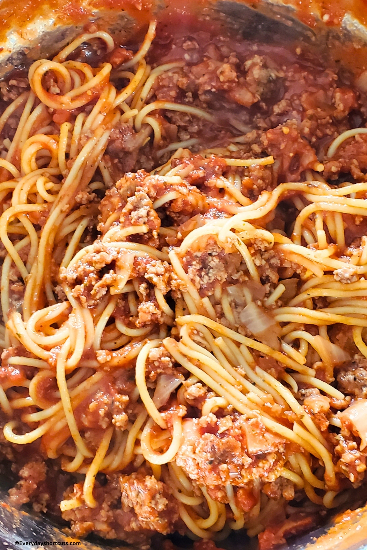 spaghetti with meat sauce in a pan