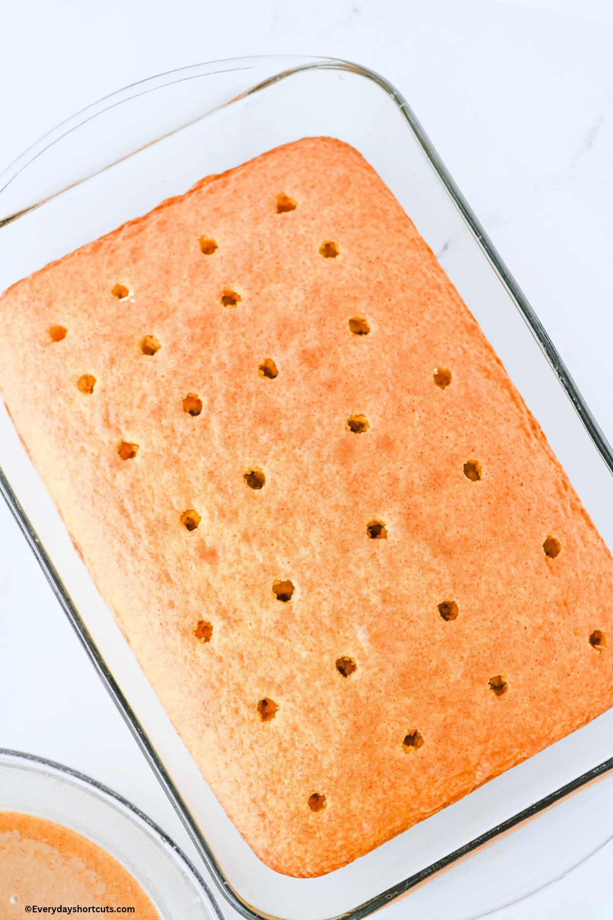 baked cake with poked holes on top