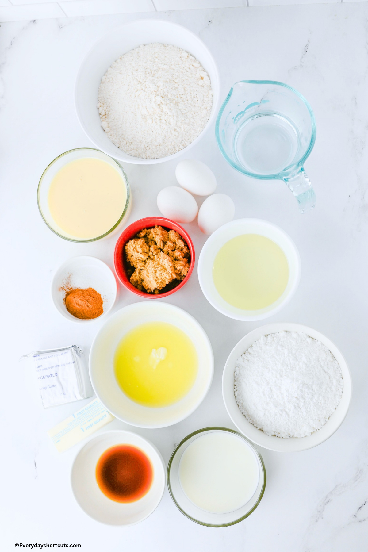 ingredients shown: cake mix, water, sweetened condensed milk, eggs, brown sugar, cinnamon, oil, melted butter, cream cheese, vanilla extract, powdered sugar, milk, salt