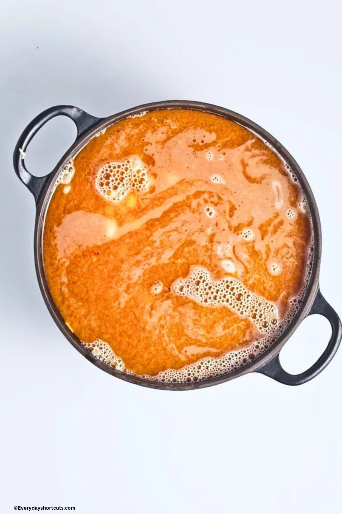 pumpkin puree, beans, vegetable broth, onion, garlic and seasonings cooking in a pan