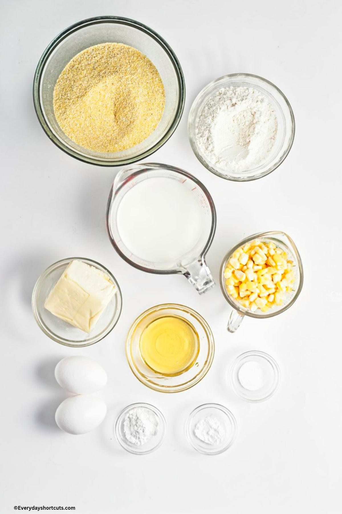 ingredients shown: eggs, whole milk, honey, yellow cornmeal, all-purpose flour, unsalted butter, fresh corn kernels, baking powder, baking soda and salt