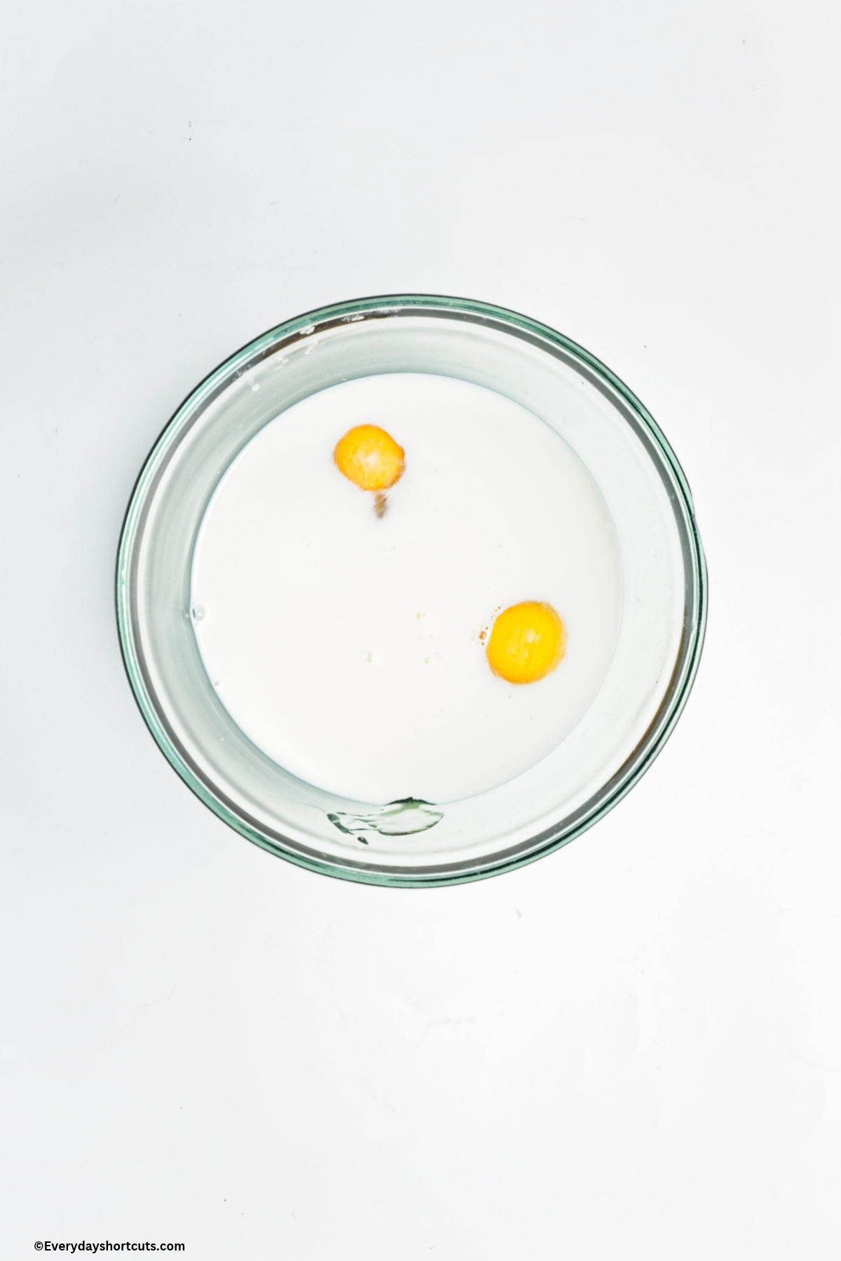eggs, milk and honey in a bowl