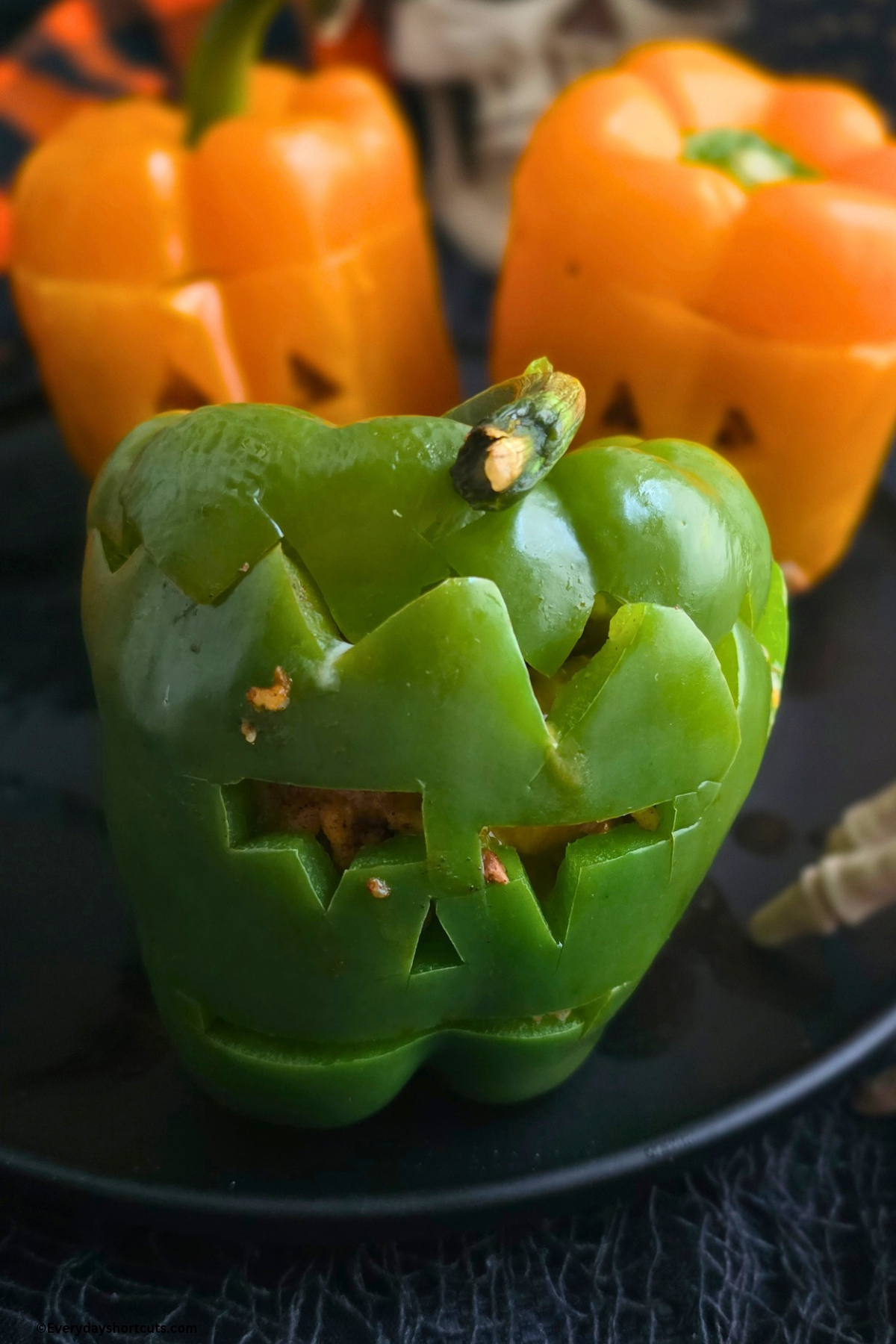 green bell pepper with a Frankenstein carved face