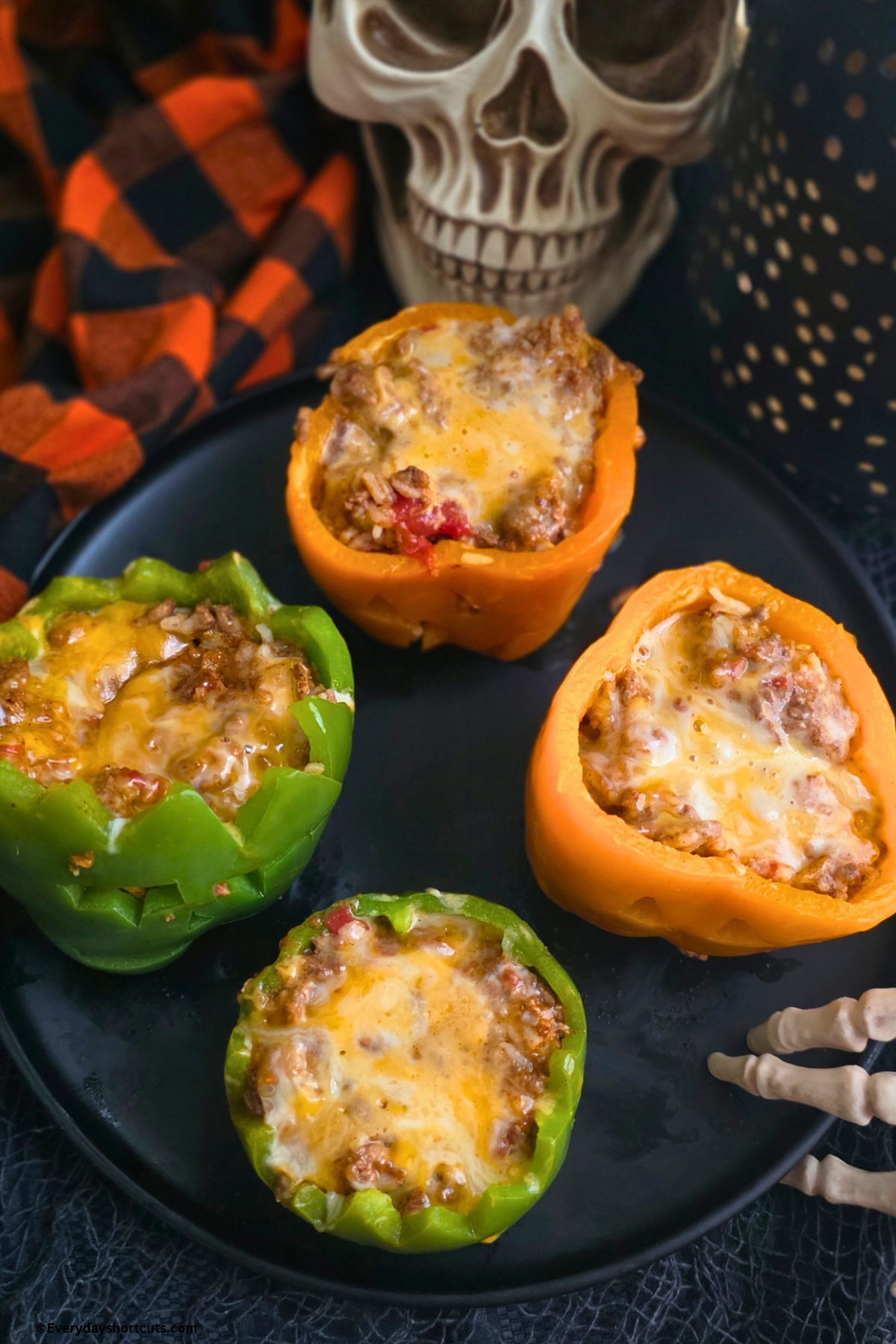 tops taken off stuffed peppers on a black plate