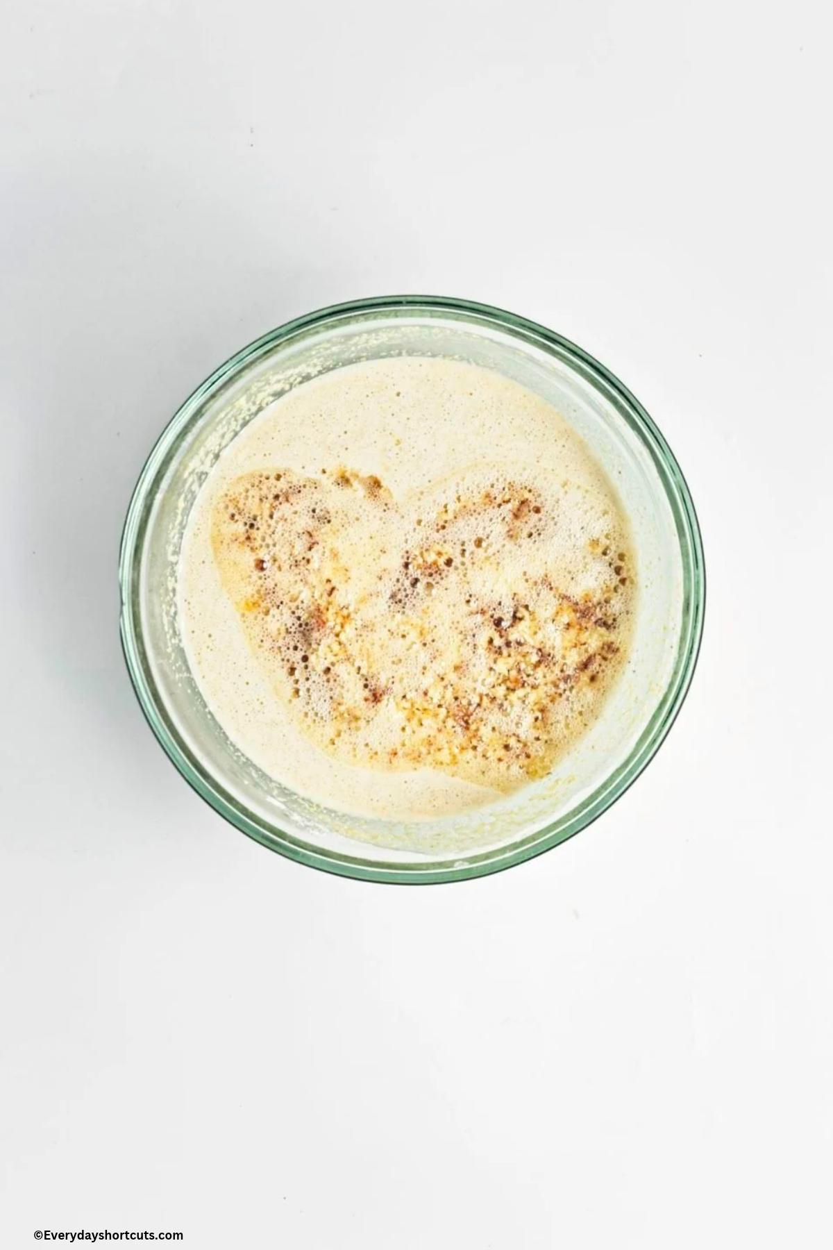 brown butter on top of cornbread batter in a bowl